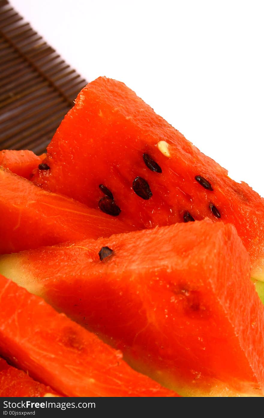 Background of brightly lit red watermelon slices.