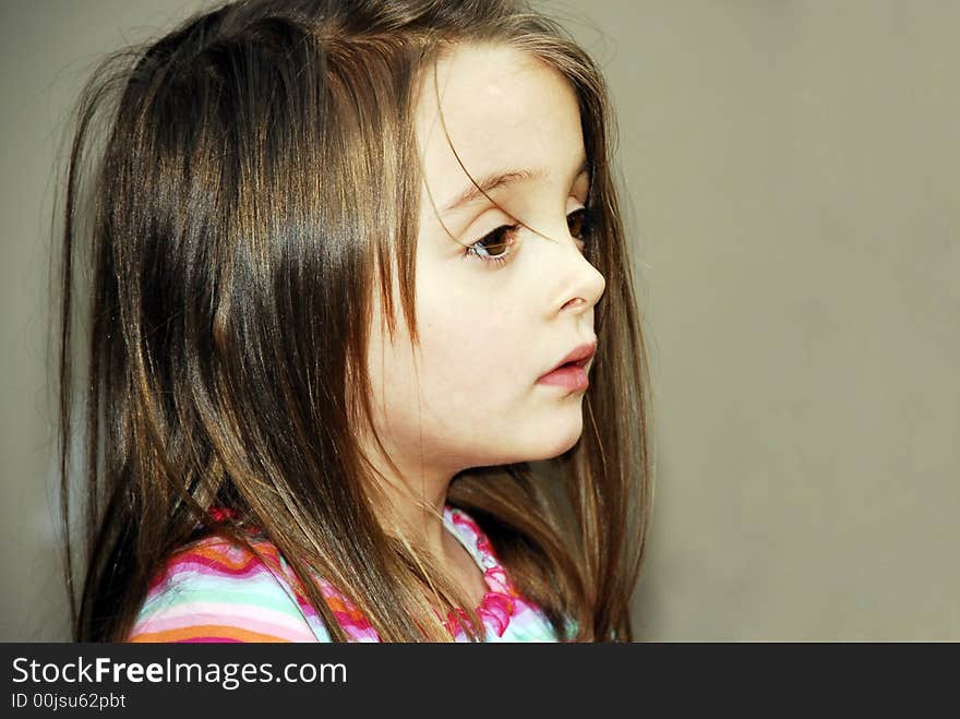 Beautiful close-up of a Brunette with her hair all over her face and huge brown eyes with long eyelashes. Beautiful close-up of a Brunette with her hair all over her face and huge brown eyes with long eyelashes.