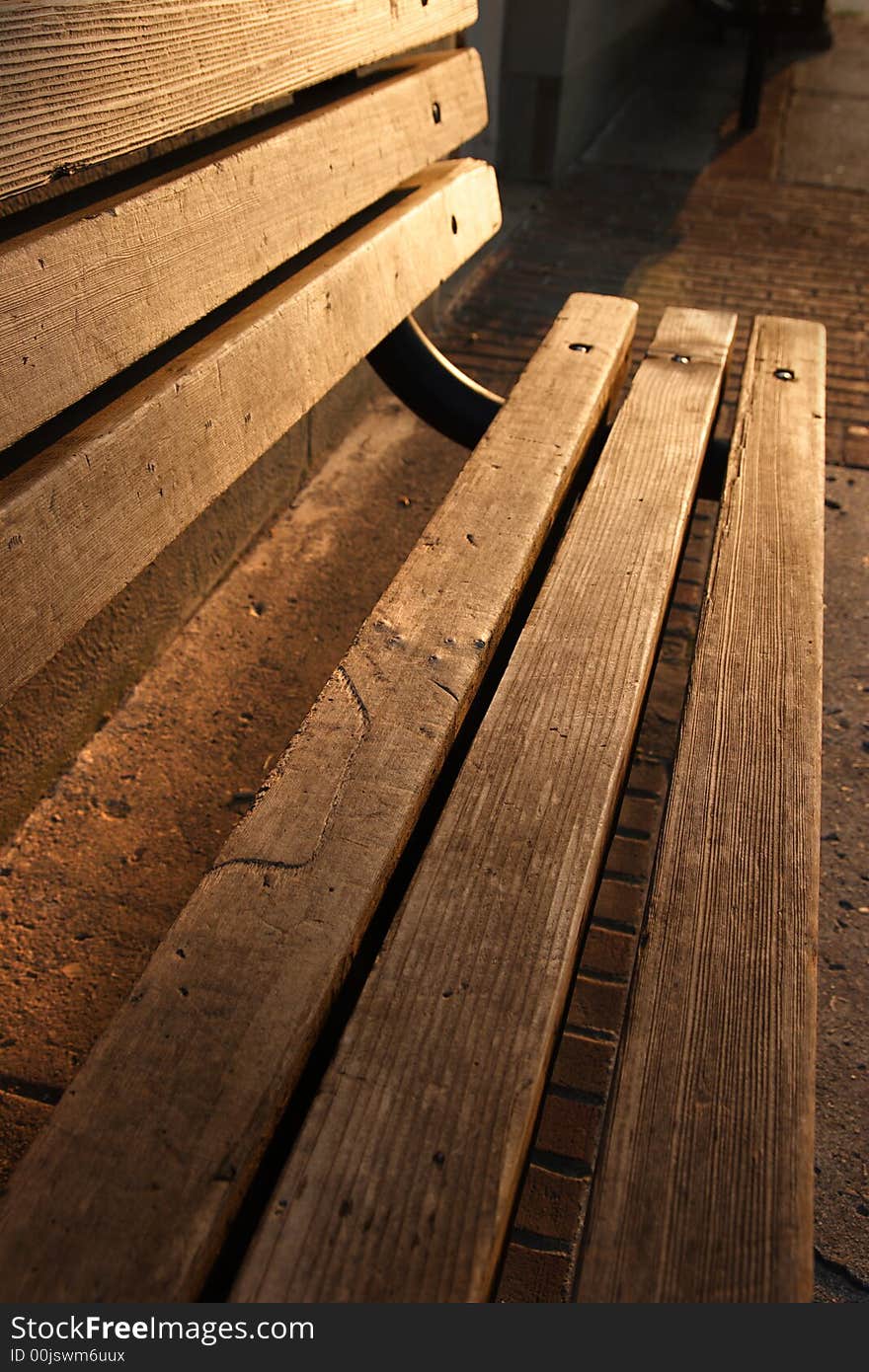 Wooden bench bathed in morning sunlight. Wooden bench bathed in morning sunlight