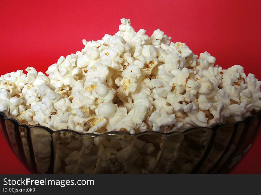 Popcorn bowl isolated on red