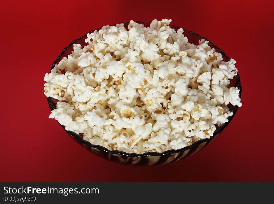 Popcorn bowl isolated on red