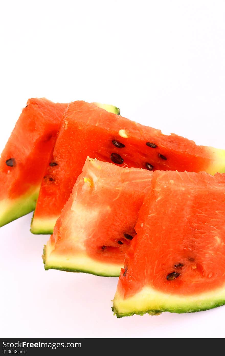 Background of brightly lit red watermelon slices.