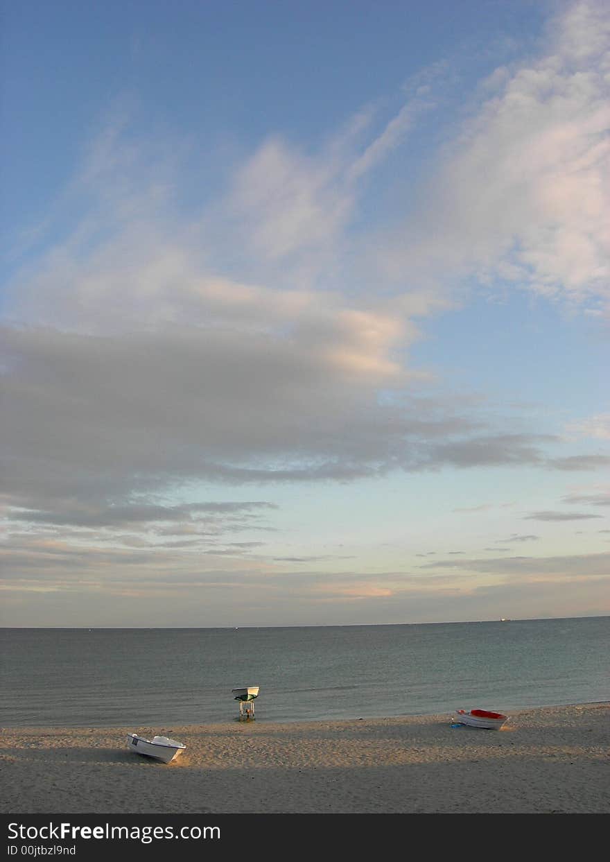 Sandy beach beatiful clouds in sunset