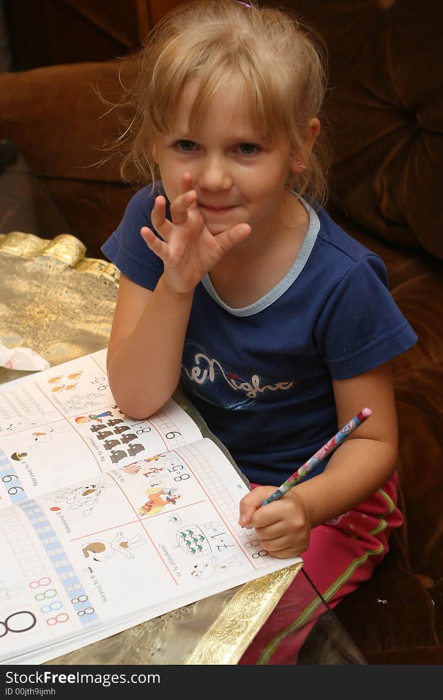 Young girl is learning from her first book. Young girl is learning from her first book