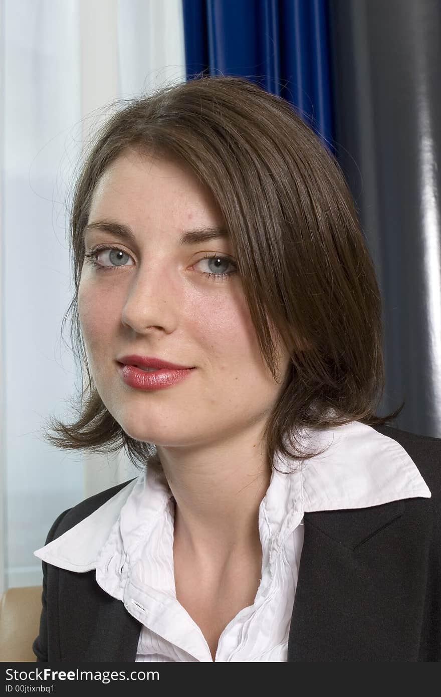 A portrait of a young attractive businesswoman facing camera. A portrait of a young attractive businesswoman facing camera