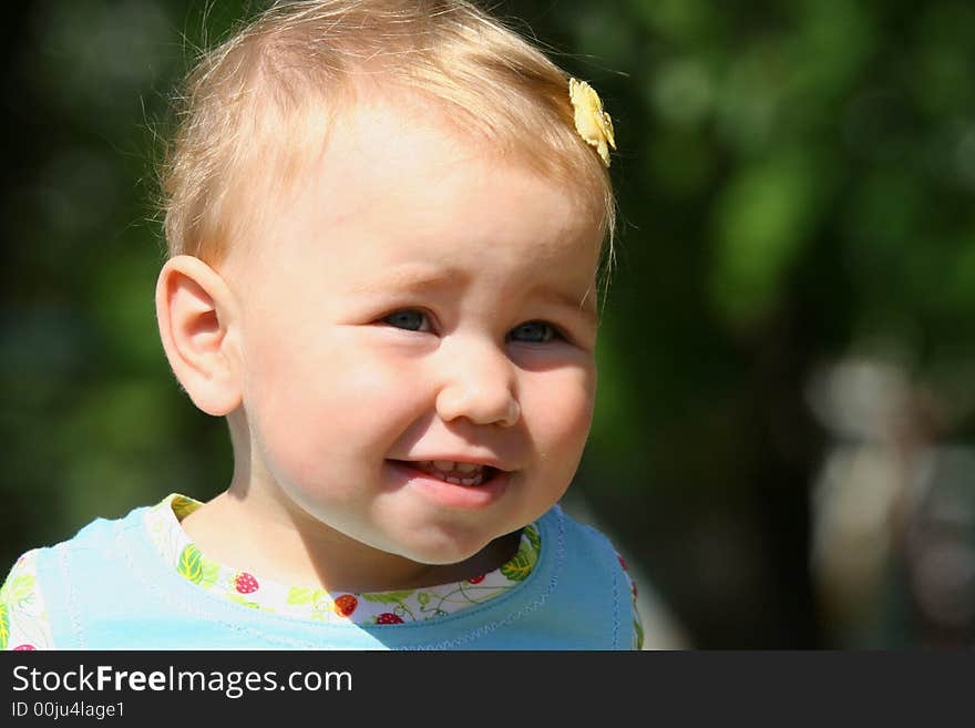 Little smiling girl on the green backstage. Little smiling girl on the green backstage