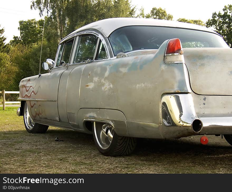 A Cool and beat up 1950s classic american car painted with red flames. A Cool and beat up 1950s classic american car painted with red flames