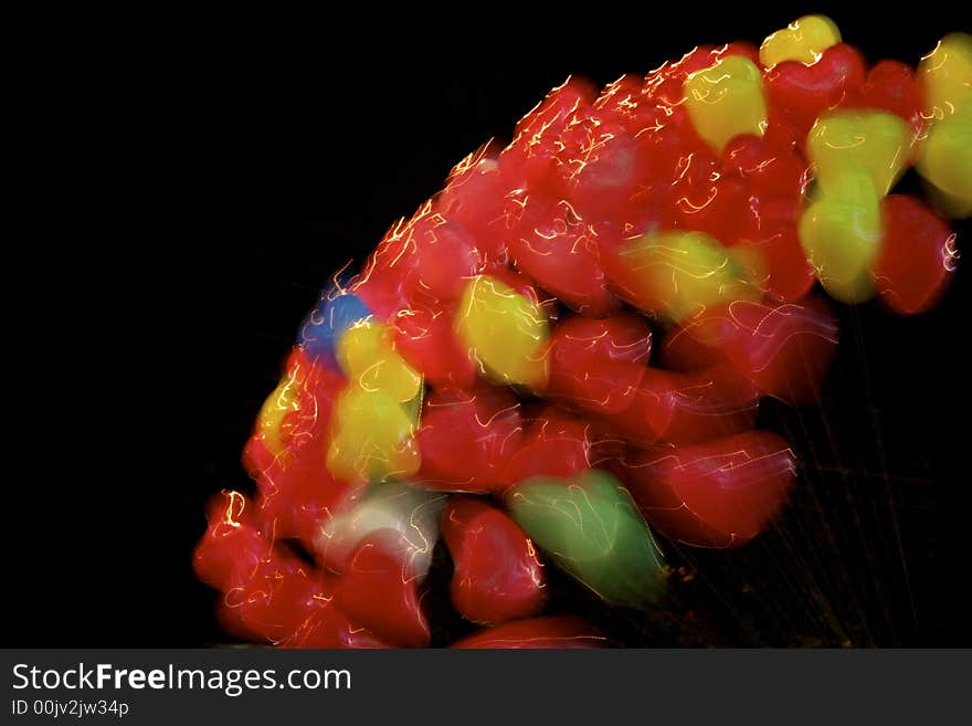 A group of colourful balloons heart shaped on a black baground; motion blur. A group of colourful balloons heart shaped on a black baground; motion blur