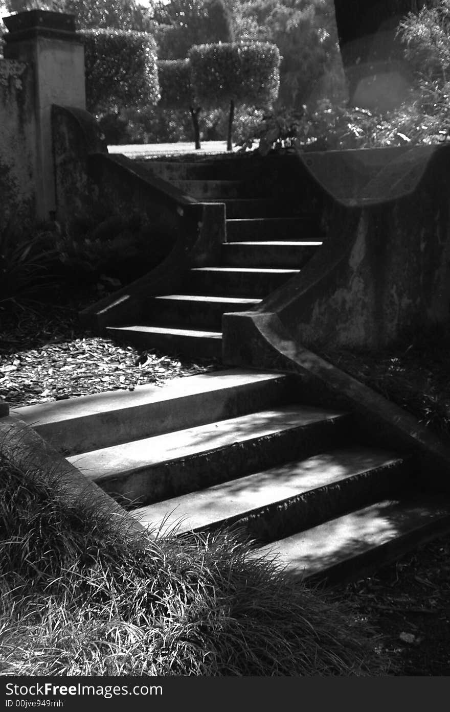 Shadowy garden staircase in an outdoor garden. Shadowy garden staircase in an outdoor garden