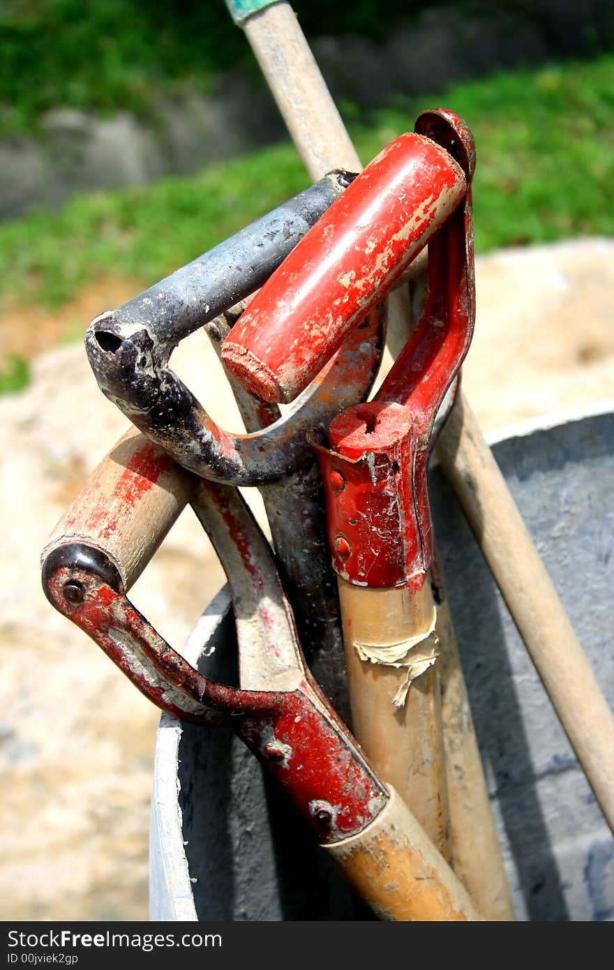 Handles of construction tools put aside during break time. Handles of construction tools put aside during break time.