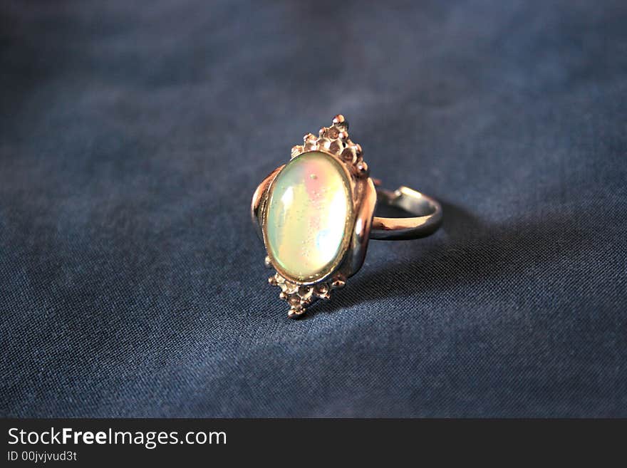 Nice ring with colorful stone on the gray. Nice ring with colorful stone on the gray.