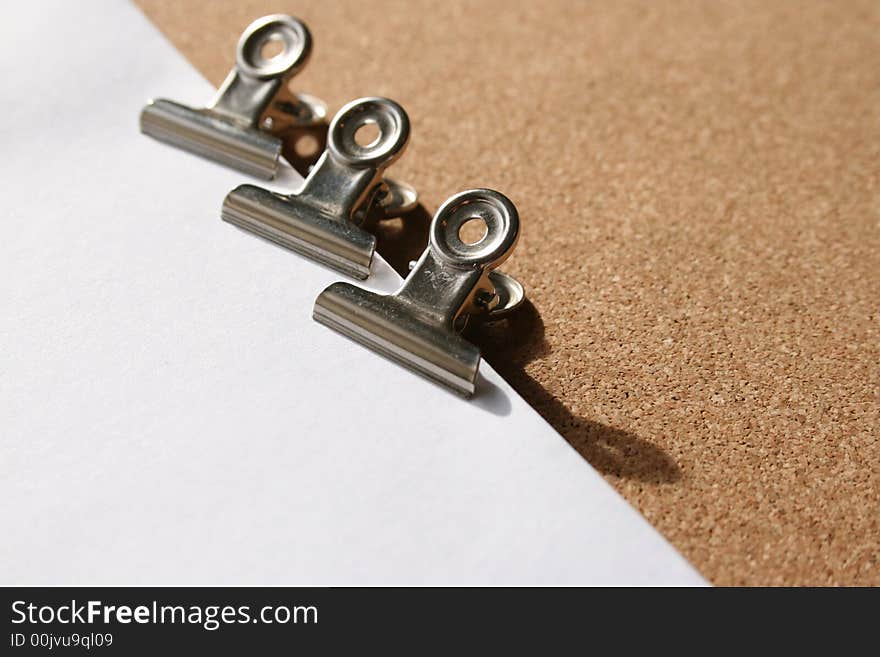 Bullfrog clips on white sheets and cork background