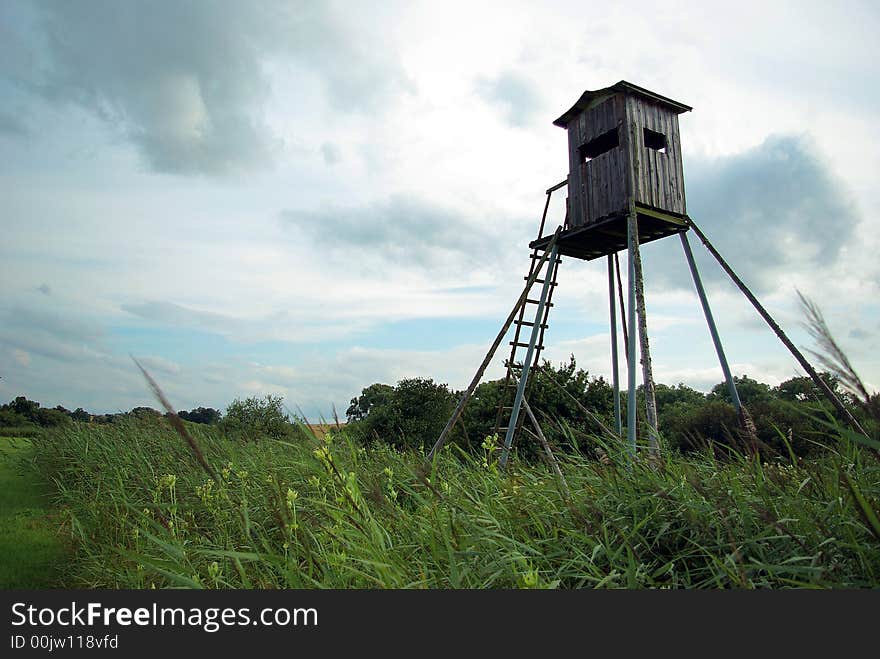 Elevated hunt shelter made in wood in the countryside.