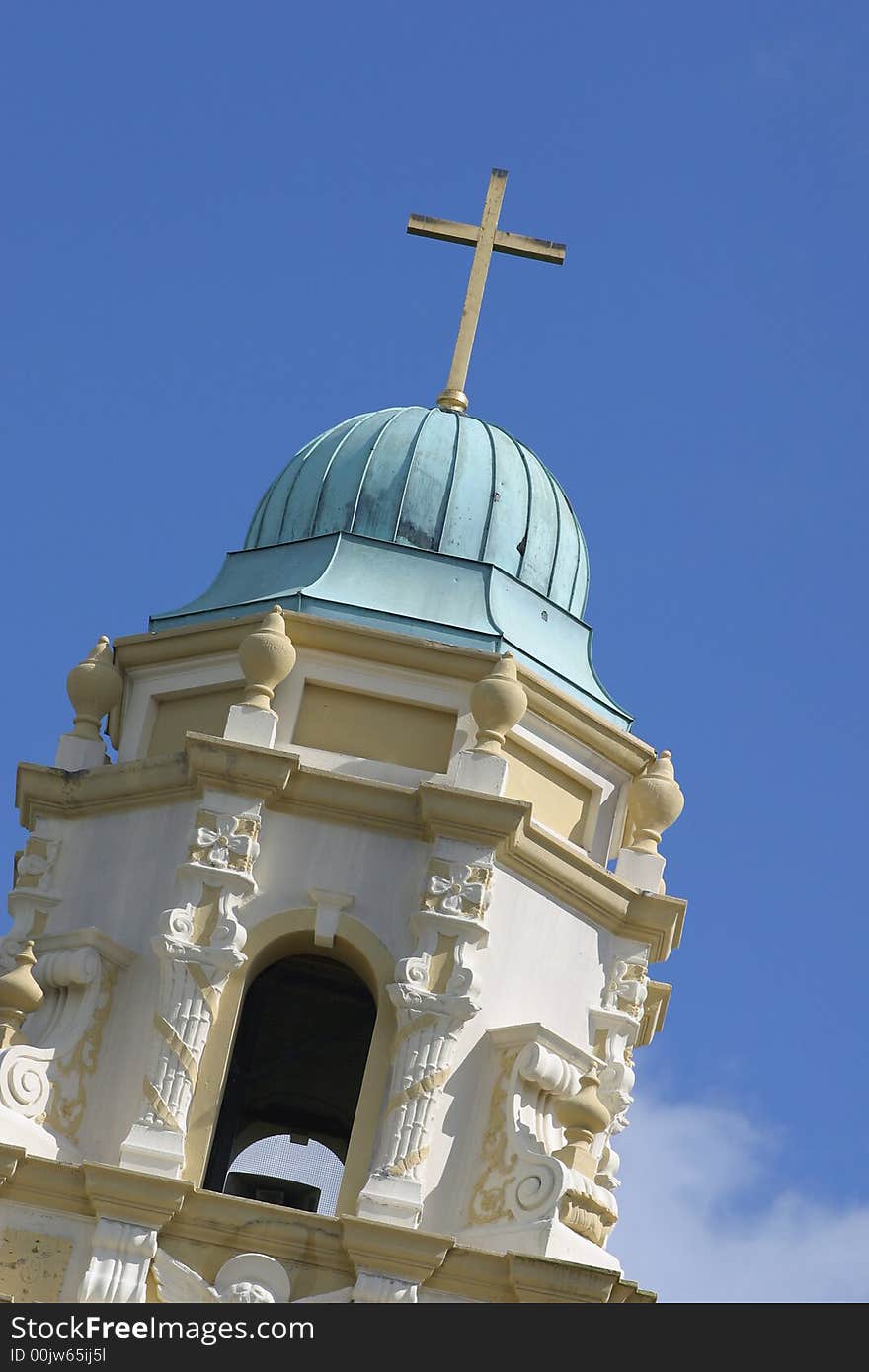 Top of a church tower with a cross on blue sky. Top of a church tower with a cross on blue sky.