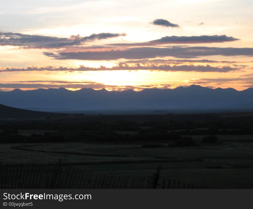 Sun rising through clouds in the rockies. Sun rising through clouds in the rockies