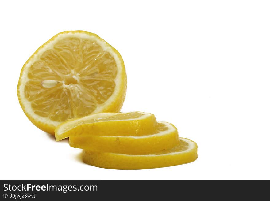 A yellow lemon with tree slice over white background. A yellow lemon with tree slice over white background