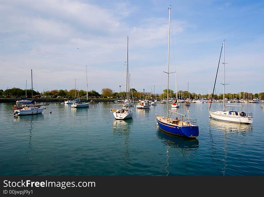 Sailboats moored in bay with blue water. Sailboats moored in bay with blue water