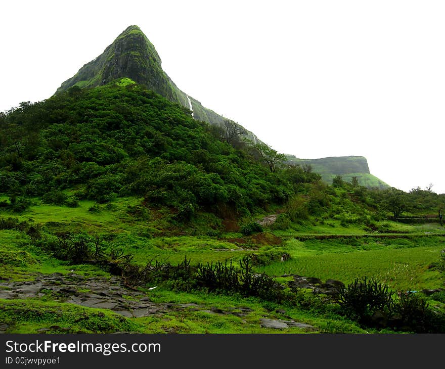 The distant and dark green mountain in India. The distant and dark green mountain in India.