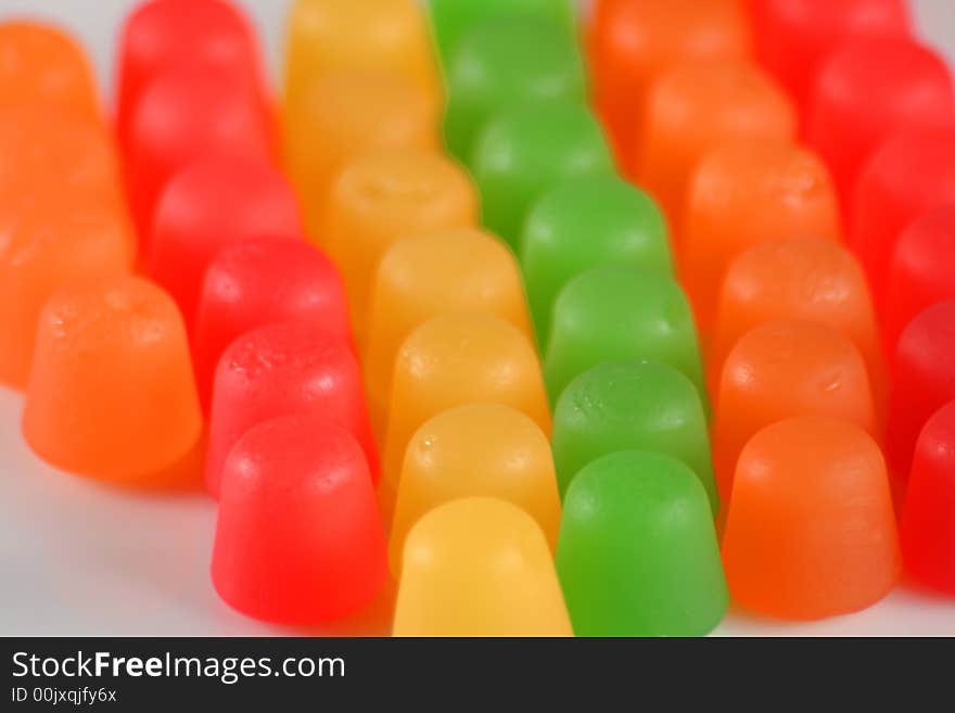 Colorful gummy candy in a line on white. Colorful gummy candy in a line on white