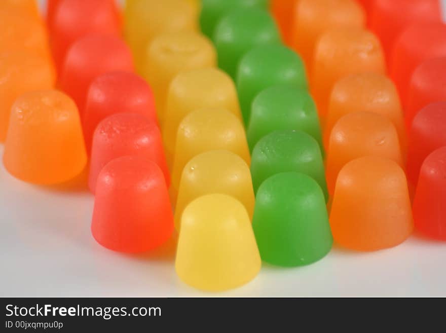 Colorful gummy candy in a line on white. Colorful gummy candy in a line on white