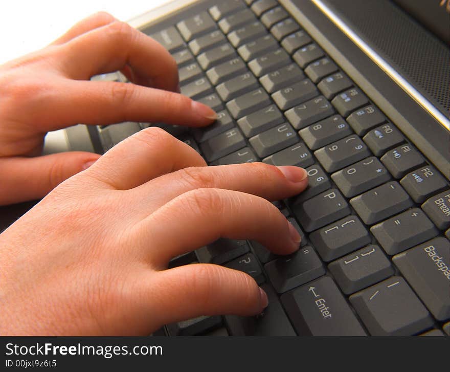 A businesswoman typing on a laptop