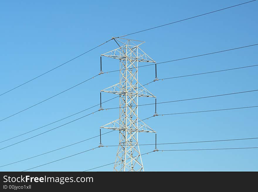 Electricity pylon against blue