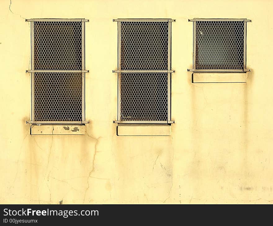 Security grids on an industrial building's windows. Security grids on an industrial building's windows.