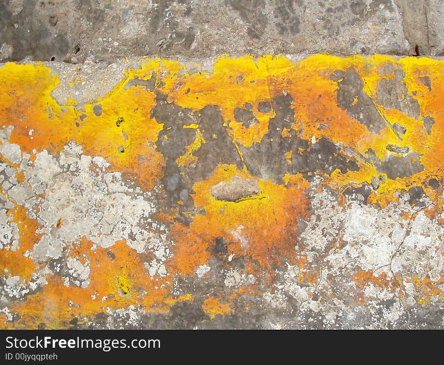 Old yellow paint on eroded concrete. Old yellow paint on eroded concrete