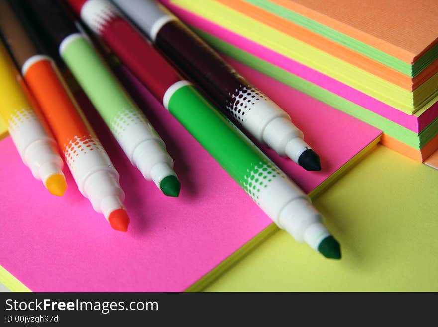 Colorful pencils over colored peaces of paper. Colorful pencils over colored peaces of paper