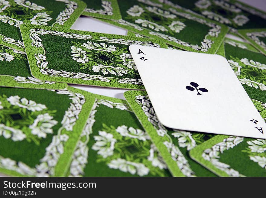 Ace laying on the other cards on the table on the other cards