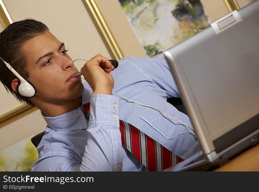 Young business man is looking at his laptop. Young business man is looking at his laptop