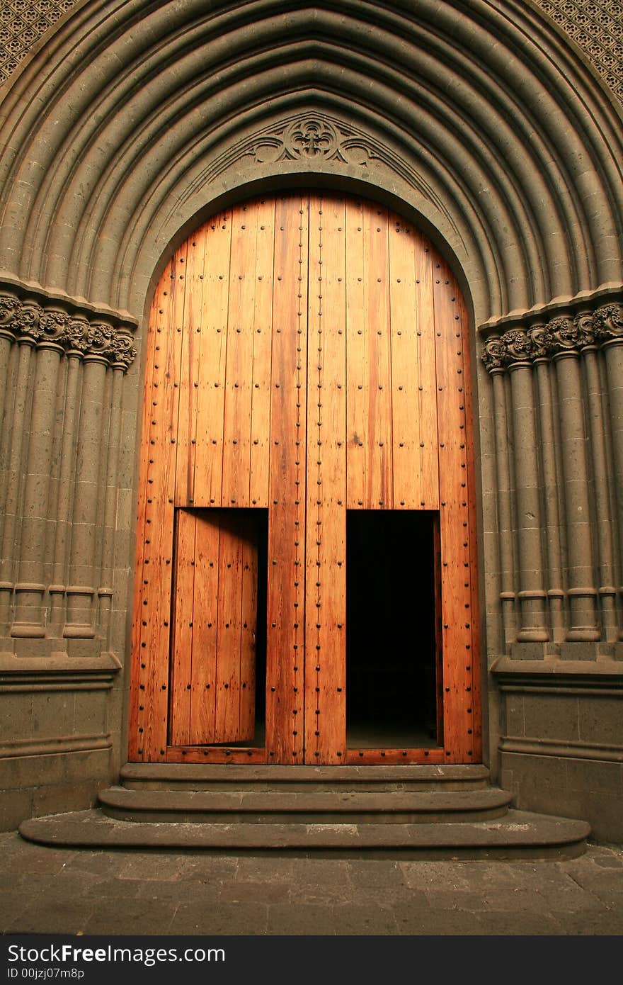 Wood, golden, entrance gates to San Juan cathedral in Arucas, Great Canary island, built in neogothic style last century. Wood, golden, entrance gates to San Juan cathedral in Arucas, Great Canary island, built in neogothic style last century