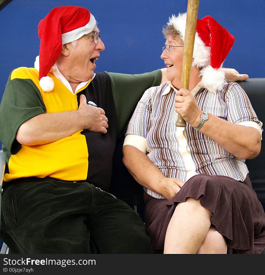 Wife giving her husband a present at christmas. Wife giving her husband a present at christmas