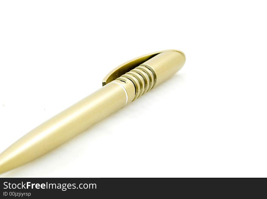 Golden plastic pen on white background.