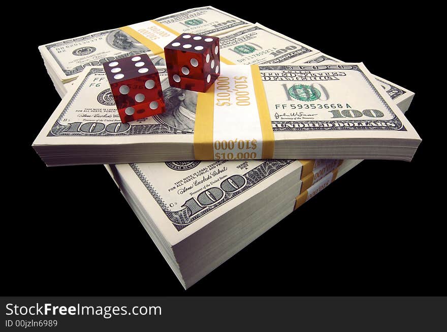 Stack of Hundred Dollar Bills & Red Dice on a black background.