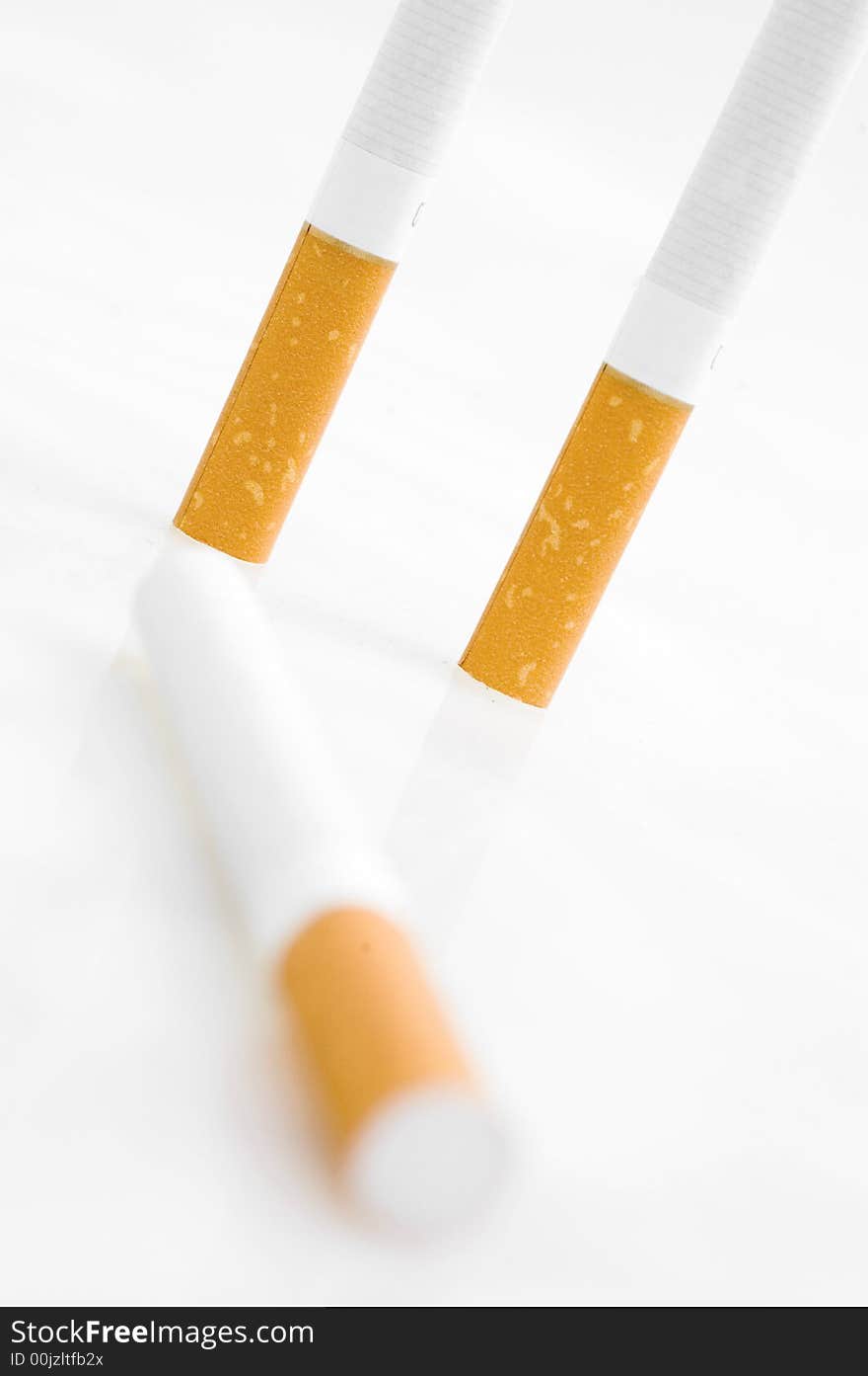 Three cigarets on white background.