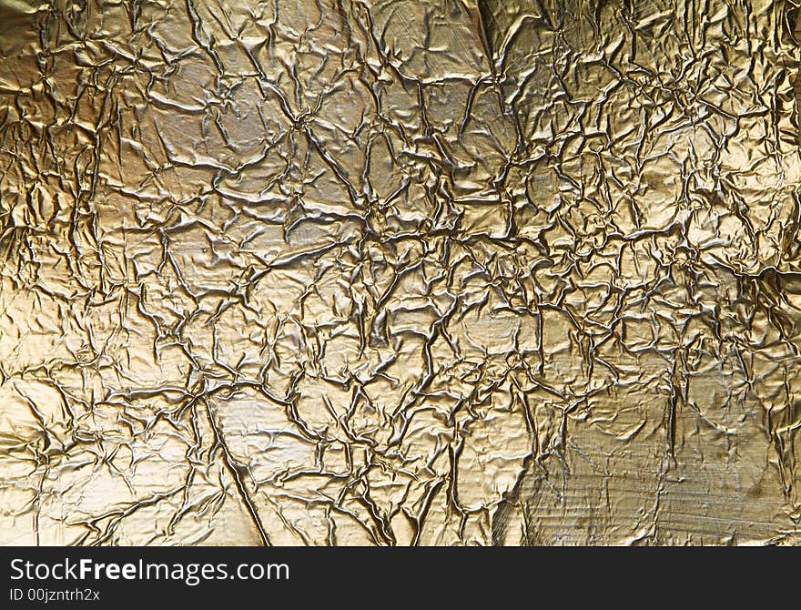 Wrinkled and scratched golden metal background. Wrinkled and scratched golden metal background