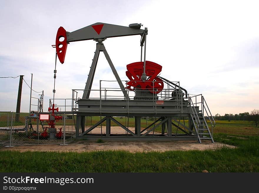 Oil pump on a green field. Oil pump on a green field.