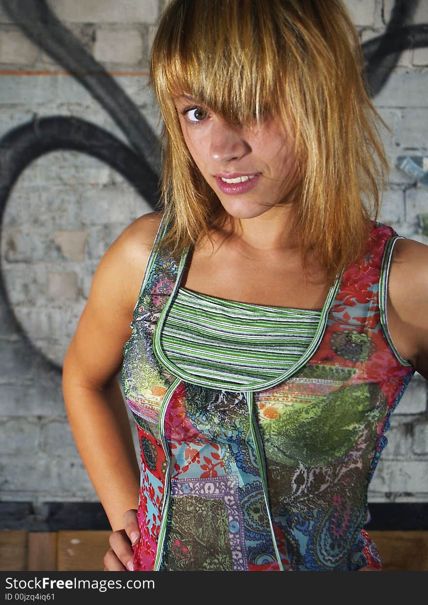 Sexy girl standing front of a graffiti brick wall. Sexy girl standing front of a graffiti brick wall