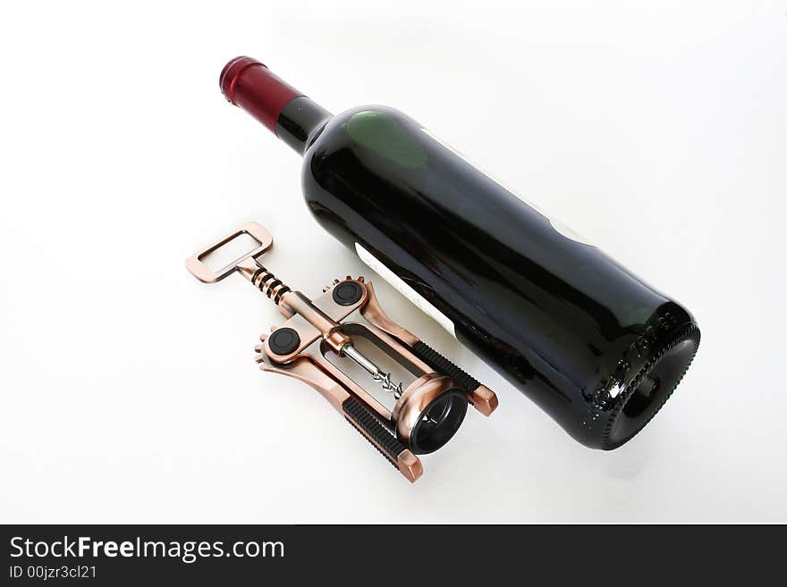 Red wine and an corkscrew isolated on a white background. Red wine and an corkscrew isolated on a white background