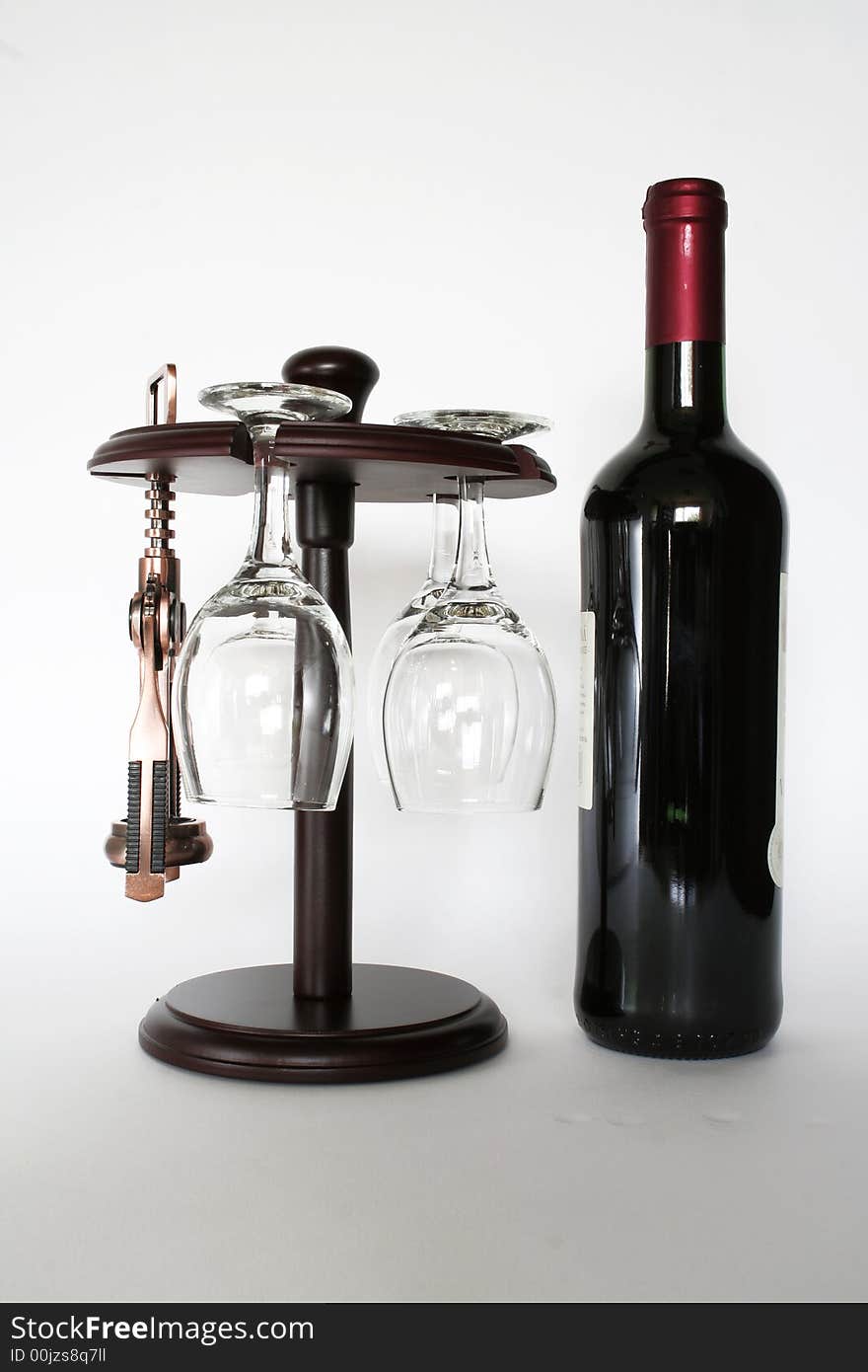 Red wine and an corkscrew isolated on a white background. Red wine and an corkscrew isolated on a white background