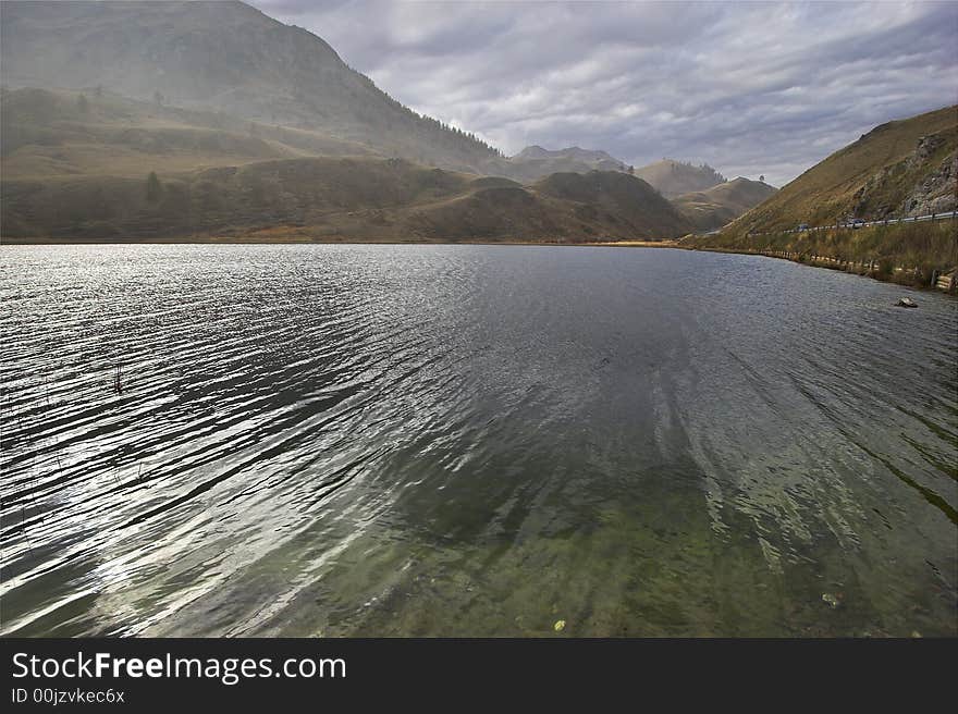 Mountain lake in the Swiss Alpes in cloudy autumn day. Mountain lake in the Swiss Alpes in cloudy autumn day