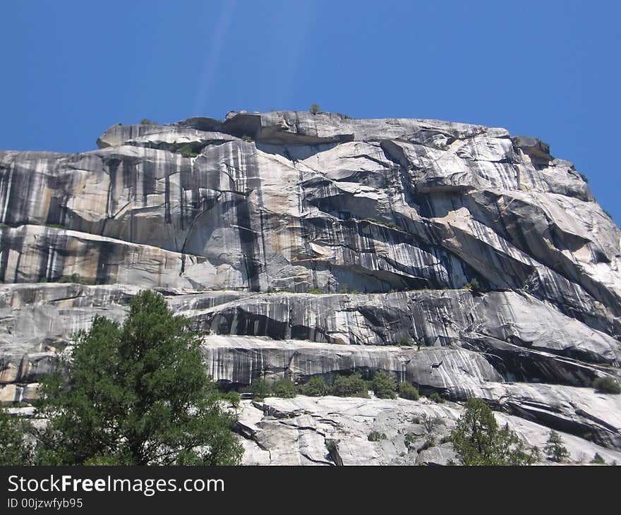 Staring up at the many mountains and geological formations from the base of Yosemite Valley, one is amazed by the colors and striations.  Look at the blacks and oranges and the textures inscribed in this rock!