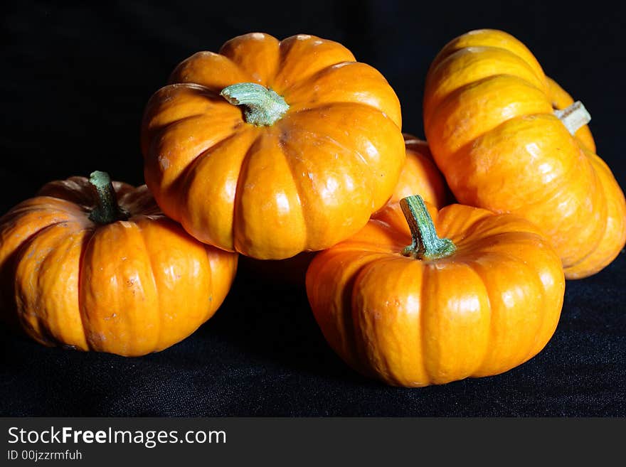 Vivid pumpkins against a black background - perfect for fall festivities.