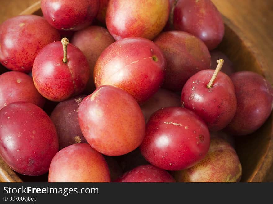 Fresh plums in a wooden bowl. Fresh plums in a wooden bowl