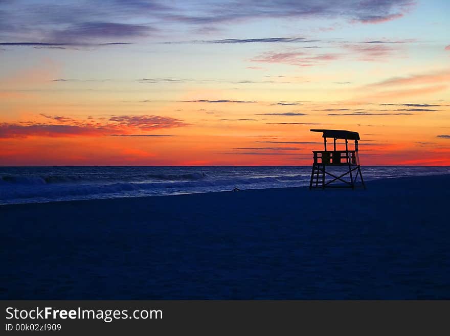 Sunset at the beach with life guard stand. Sunset at the beach with life guard stand