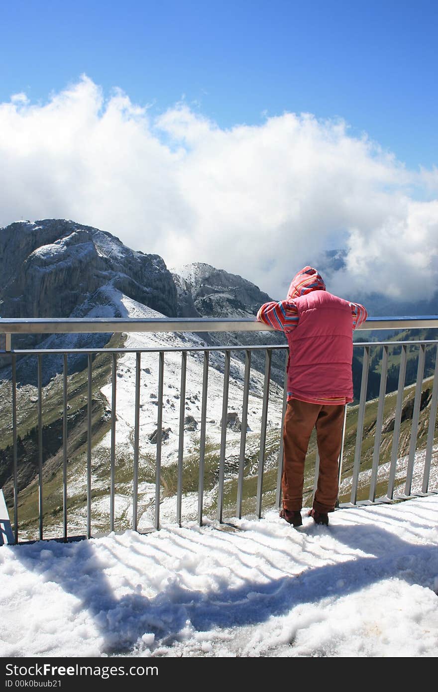 Child looking out at the Swiss Alps from the top of Mount Pilatus. Child looking out at the Swiss Alps from the top of Mount Pilatus.