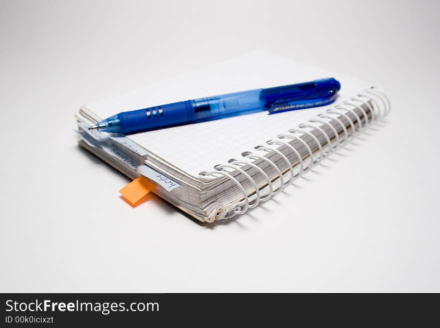 Pen and notebook isolated on grey