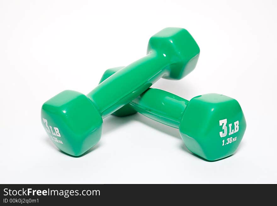 Green dumbbells isolated on white background