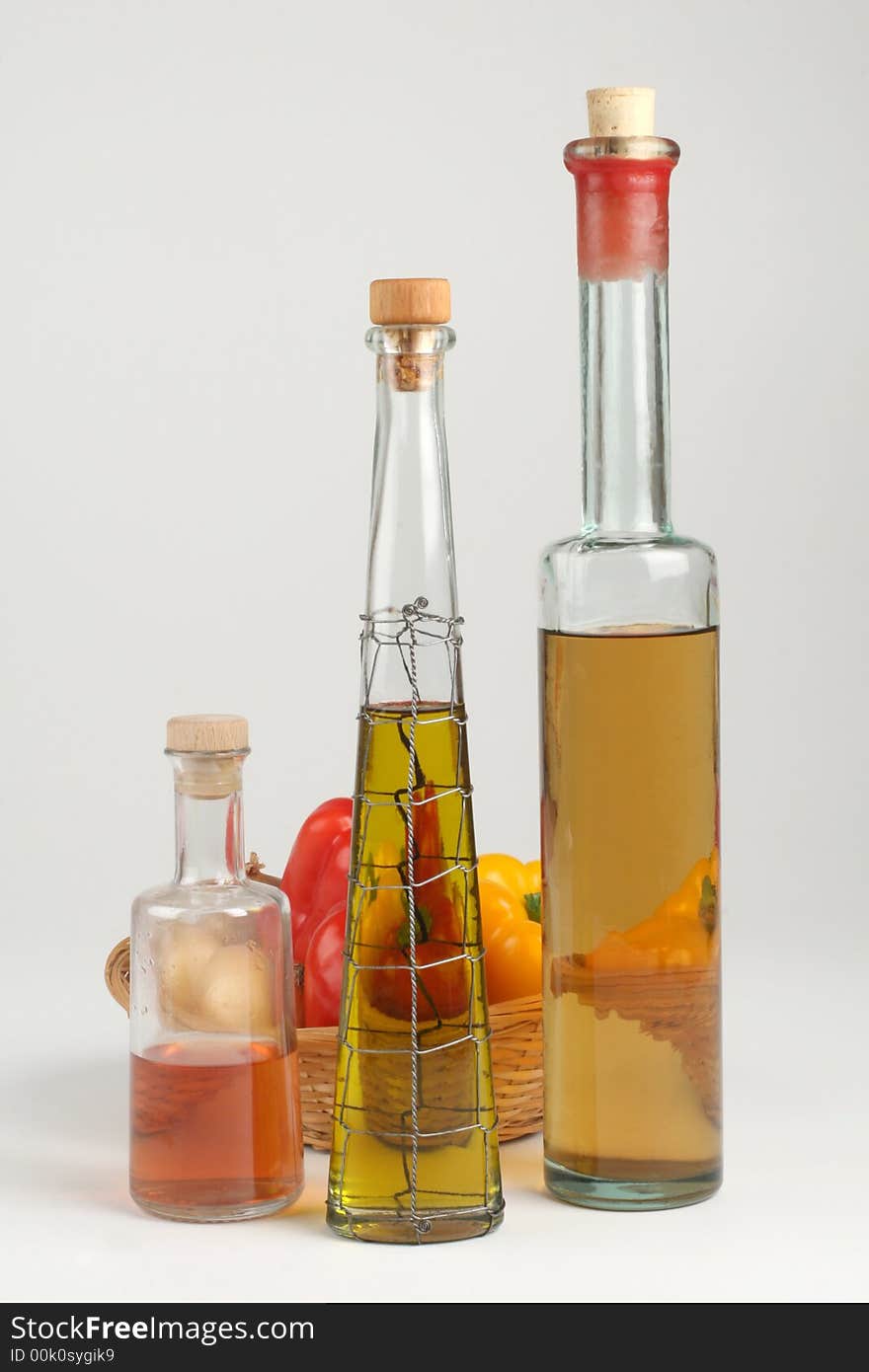 Still life of oil and basket with peppers. Still life of oil and basket with peppers